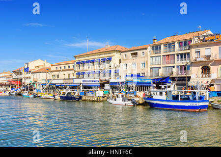 Boats moored in front of the Hotel Belle-Vue d’Angleterre along Quay Colbert, Le Grau-du-Roi, Gard, France Stock Photo