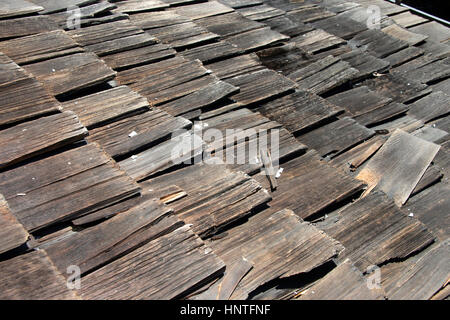 Wood shake shingle roof more then 30 years old decaying and falling apart. Exceeded life expectancy and needs to be replaced. Stock Photo