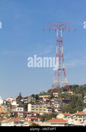 Huge pylon and power line above a residential area. Stock Photo