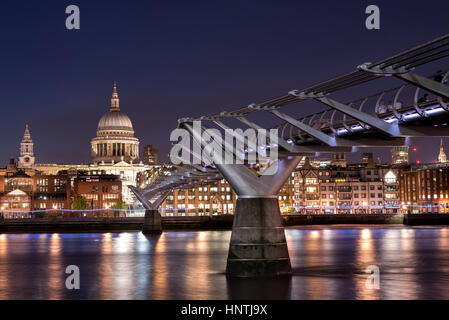 Night time view of the Millennium Bridge and River Thames, London, UK, with St Paul's Cathedral, lit up on the opposite bank of the river Stock Photo