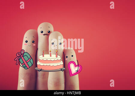 Four fingers decorated as four person celebrating birthday together. Stock Photo