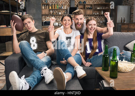 friends supporting favorite football team Stock Photo