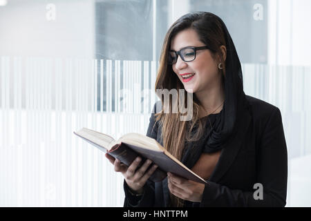 Female student with text books in a university setting. Stock Photo