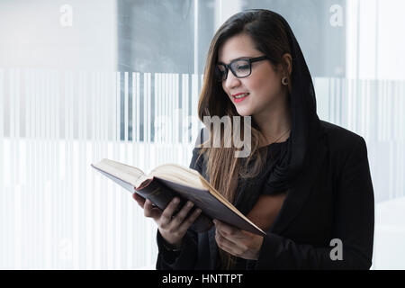 Female student with text books in a university setting. Stock Photo