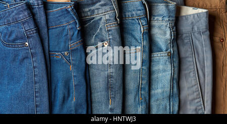 Selection of different blue color jeans lay on stack Stock Photo