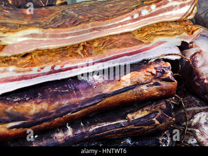 Homemade bacon on the table exposed for sale. Stock Photo