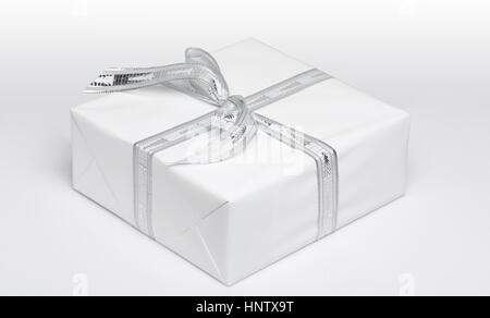 One white gift box with white ribbon view from angle isolated Stock Photo