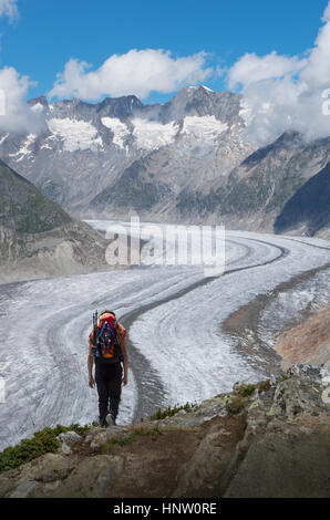 Caucasian man hiking in snowy mountains Stock Photo