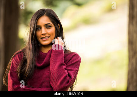 Portrait of smiling Indian woman wearing sweater Stock Photo