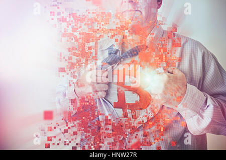 Caucasian businessman opening shirt revealing Bitcoin symbol Stock Photo