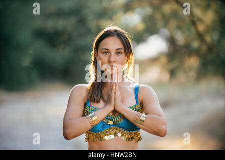 Caucasian belly dancer with hands clasped Stock Photo