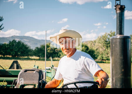 Portrait of Caucasian farmer on tractor Stock Photo