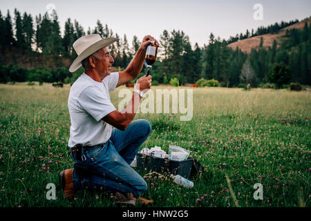 Caucasian farmer preparing vaccine in syringe Stock Photo