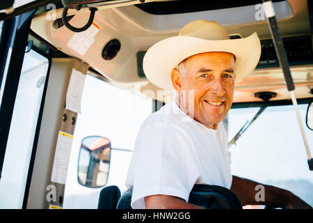 Portrait of smiling Caucasian farmer in tractor Stock Photo