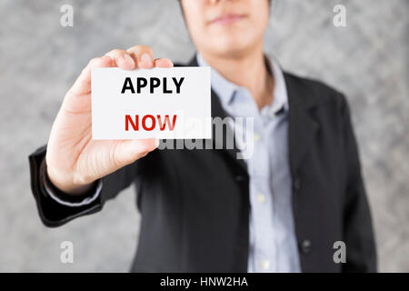 businessman showing business card with word apply now Stock Photo