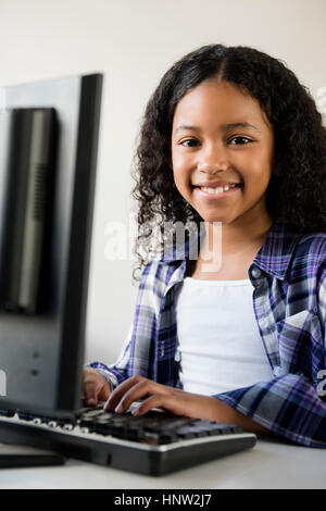 Mixed Race girl using computer Stock Photo