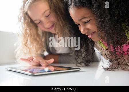 Smiling girls using digital tablet Stock Photo
