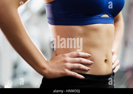 Sweating midriff of Mixed Race woman Stock Photo
