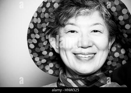Portrait of smiling Japanese woman wearing hat Stock Photo