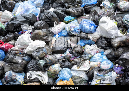 Dumpsters being full with heap of garbage overflowing Stock Photo