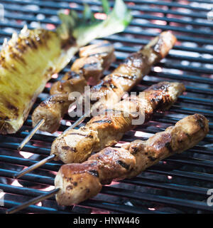 Chicken skewers cooking on grille Stock Photo
