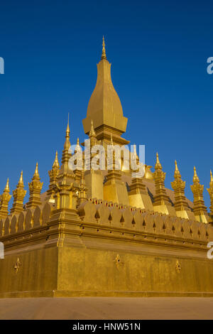 Pha That Luang stupa is the symbol of the city of Vientiane, the capital of Laos. It's a huge golden stupa, built in the year 1566. Its golden color i Stock Photo