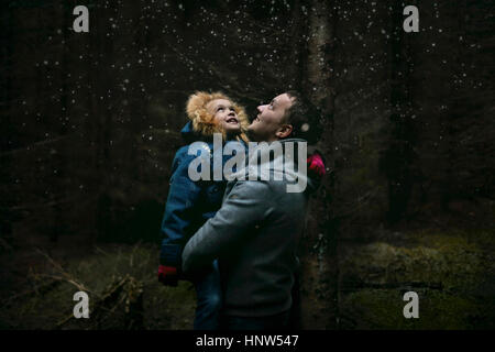 Caucasian father and daughter under starry sky Stock Photo