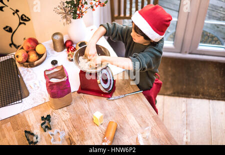 Boy weighing flour in scale Stock Photo