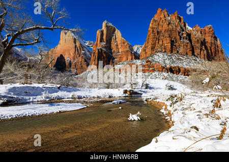 This is a view of the Court of the Patriarchs with a fresh covering of snow and the North Fork of the Virgin River in Zion National Park Utah, USA. Stock Photo