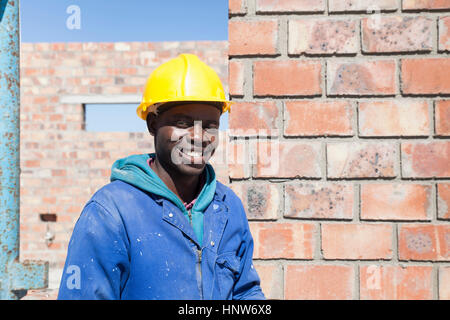 Portrait of builder wearing hard hat looking at camera smiling Stock Photo