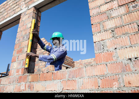 Builder working on construction site Stock Photo