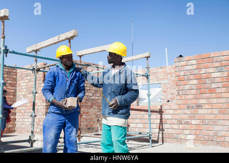 Builders talking on building site Stock Photo