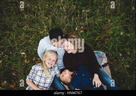 Overhead view of family lying down together on grass Stock Photo