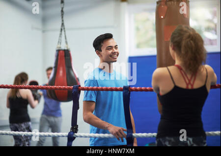 Female boxer in boxing ring  talking to male boxer Stock Photo