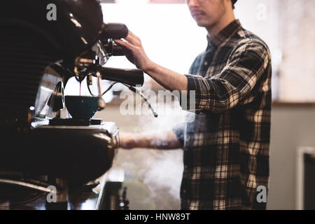 Barista preparing coffee in cafe Stock Photo