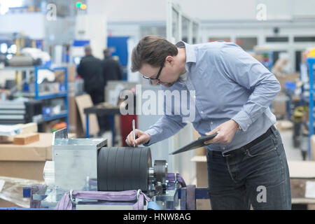 Engineer working in industrial plant Stock Photo