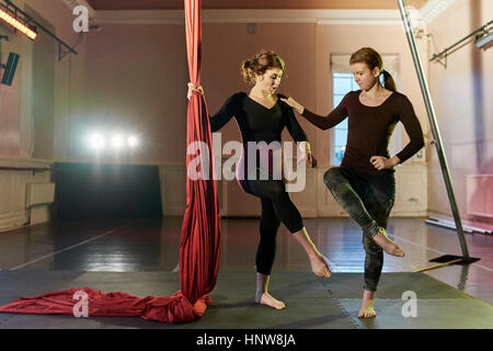 Two young female aerial acrobats practicing by silk rope Stock Photo
