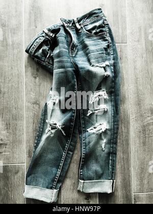Ripped Jeans on the floor Stock Photo