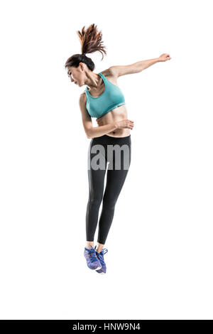 Woman in sportswears jumping Stock Photo