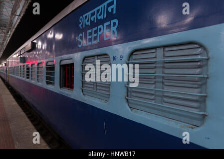 Sleeper class coach, cheap way to commute by night train in India. Stock Photo