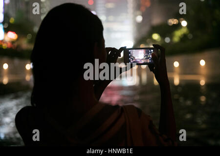 Woman against night view of city Stock Photo