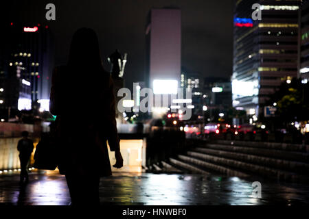 Silhouette of young woman at night Stock Photo