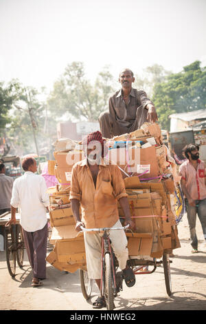 Delhi, India - September 18, 2014: Cycle rickshaw riding the vehicle under the heat on the street of Old Delhi, India on September 18, 2014. Stock Photo