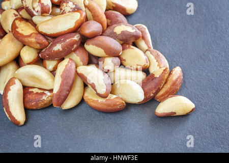 Close up picture of Brazil nuts on dark slate background. Stock Photo