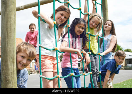 Portrait Of School Pupils Playing On Climbing Frame Stock Photo
