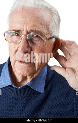 Studio Shot Of  Senior Man Suffering From Deafness Stock Photo
