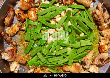 Paella from Spain recipe process ad vegetables green beans and garrofon Stock Photo