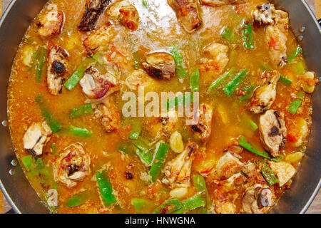 Paella from Spain recipe process ad water to get the broth boil Stock Photo