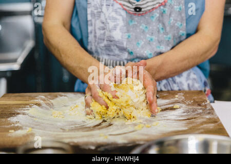Woman kneading pasta dough Stock Photo