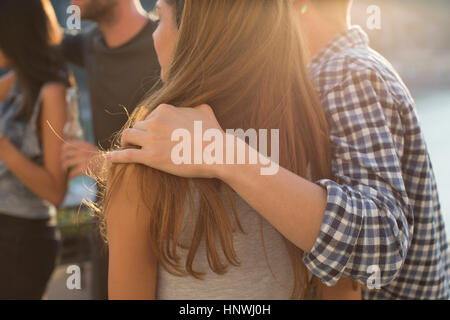 Couple and friends partying on roof terrace Stock Photo